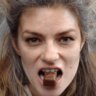 Woman holding chocolate bar in her mouth